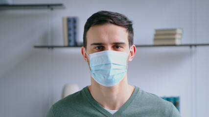 Fototapeta na wymiar Young man in a medical mask