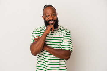 African american man with beard isolated on pink background smiling happy and confident, touching chin with hand.