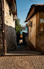A shady street of a seaside town. The inscription on the sign – "Apartments for rent". Gurzuf, Yalta, Crimea.