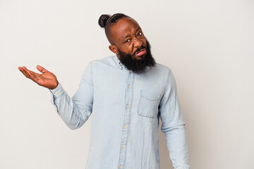 African american man with beard isolated on pink background doubting and shrugging shoulders in...