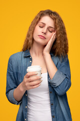 Woman with drink to go sleeping