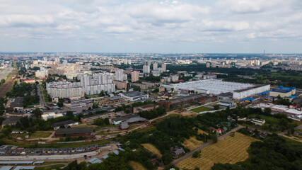 Fototapeta premium City landscape. High-rise buildings and an industrial area next door. Aerial photography.