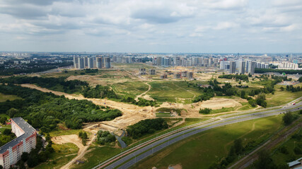 Modern urban development. Construction site with multi-storey buildings under construction. Construction work is underway. Aerial photography.