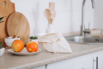 Woman's hand, holding a reusable grocery bag with vegetables.Zero waste