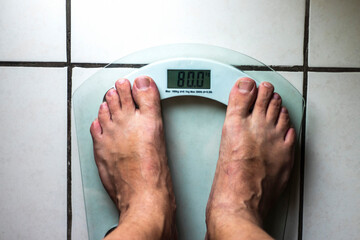 Bare feet of a mid abarefoot, closeup, diet, feet, health, healthy lifestyle, kilogram, measure,...