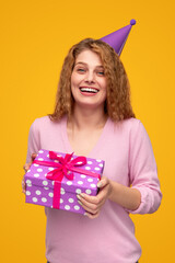 Joyful young woman with birthday present box