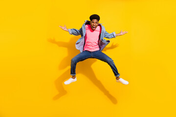 Fototapeta na wymiar Full body photo of afro american young funky man jump up wear glasses isolated on yellow color background