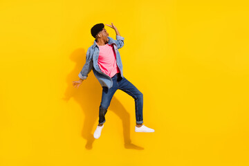 Fototapeta na wymiar Full size photo of young afro american man look empty space scream jump isolated on yellow color background