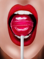 Close up of open mouth with red sexy lips. Sweets in the female mouth