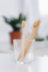 Fototapeta na wymiar Wooden teeth brushes in glass jar