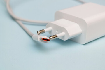 Fototapeta premium Charging for the phone on a blue background.