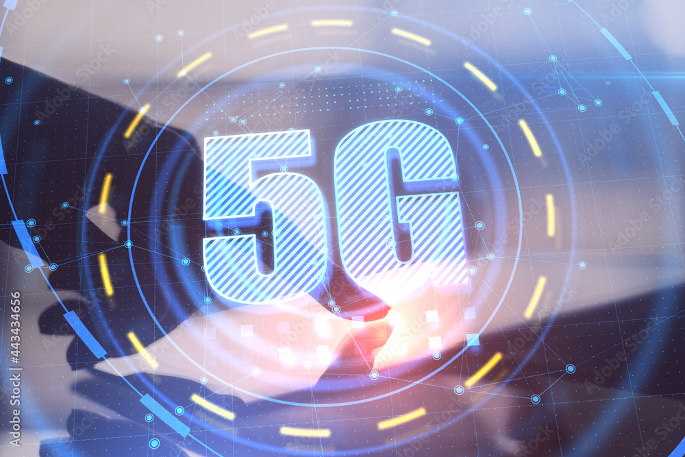 Poster backlit hand pointing at tablet on desktop with glowing 5g interface and blurry background. communic
