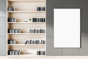 Close up of grey wooden office bookshelf with blank poster on wall. Workplace and items concept. Mock up, 3D Rendering.