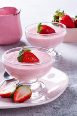 Delicious strawberry mousse in glass bowl with fresh strawberries.