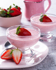 Delicious strawberry mousse in glass bowl with fresh strawberries.