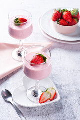 Delicious strawberry mousse in glass bowl with fresh strawberries. Copy space