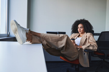 Business woman relaxing in her office at daytime