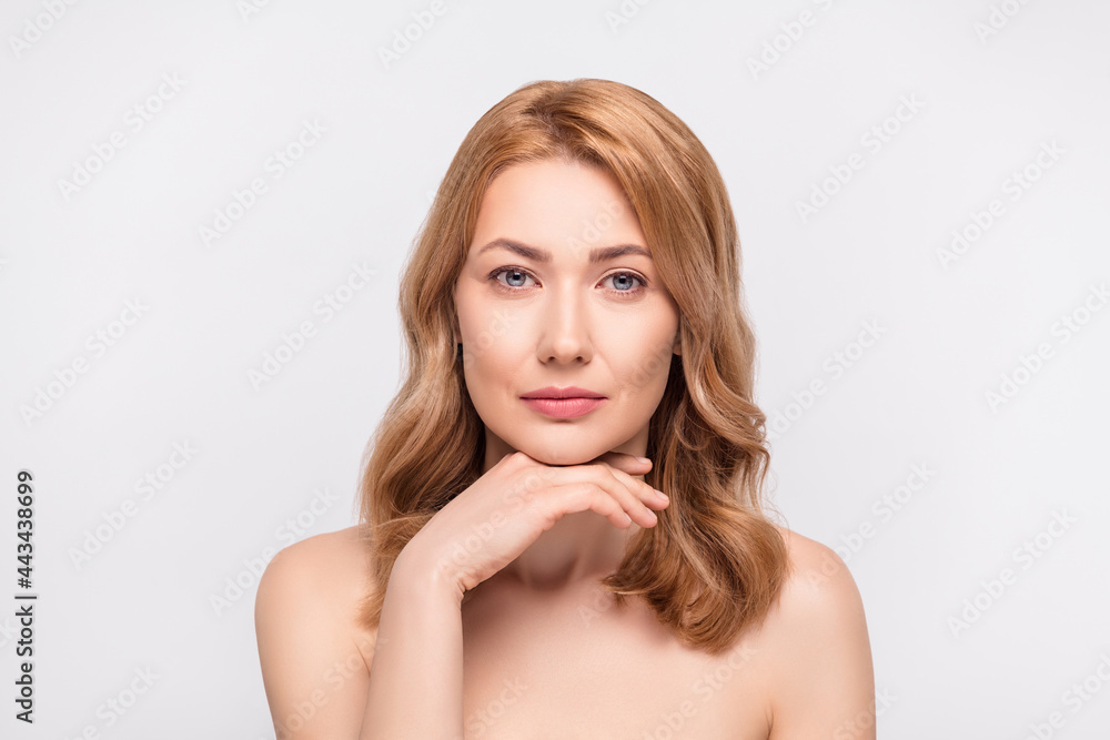 Poster Photo portrait woman with blonde hair touching chin serious calm isolated white color background