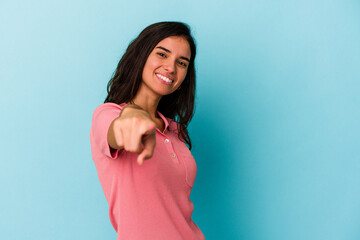Young caucasian woman isolated on blue background cheerful smiles pointing to front.