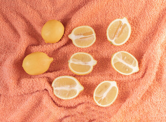 Lemons on peach color background. Summer creative concept.