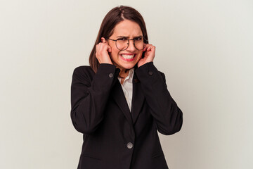 Young business woman isolated on white background covering ears with hands.