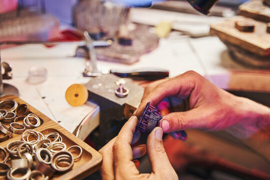 Person In Jeweler Workshop Holding Purple Ring Model