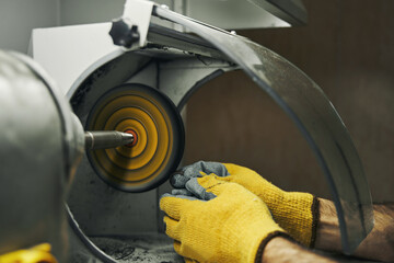 Abrasive wheel grinder used for polishing silver ring - obrazy, fototapety, plakaty
