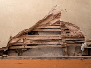Detail of old lath and plaster wall in abandoned derelict building. - obrazy, fototapety, plakaty