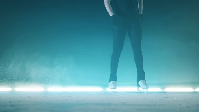 Figure skater stops gliding and stands on the ice