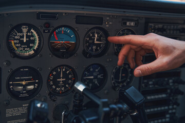 Male hand pointing at aircraft instrument panel