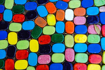 Top view on pieces of multicolored ceramic tiles decorated in garden. Old pavement of tiles textured. Street mosaic cobblestone sidewalk. Abstract,background and pattern of ceramic tile on the floor.