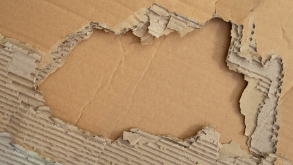 Frame made of brown beige old damaged torn paper, cardboard pattern texture background