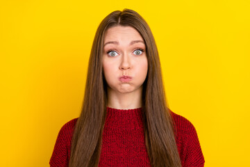 Portrait of attractive funny playful girlish long-haired girl holding breath fooling isolated over...