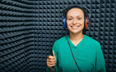 Portrait adult woman while hearing check-up at soundproof audiometric cabin using audiometry...