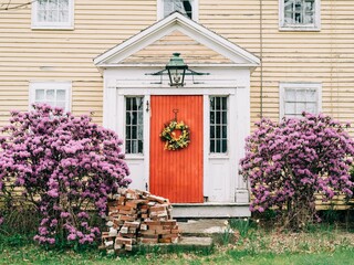 A house with a red door and pink flowers, Damariscotta, Maine