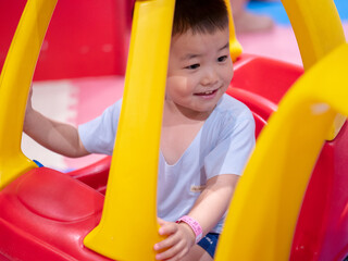 Fototapeta na wymiar Chinese little boy playing in indoor playground