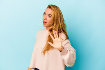 Fototapeta premium Caucasian woman isolated on blue background being shocked due to an imminent danger