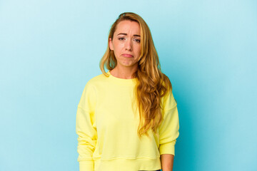 Caucasian woman isolated on blue background sad, serious face, feeling miserable and displeased.