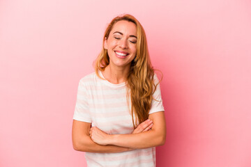 Fototapeta premium Caucasian blonde woman isolated on pink background laughing and having fun.