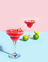 Cold strawberry margarita or daiquiri cocktail with lime and rum
