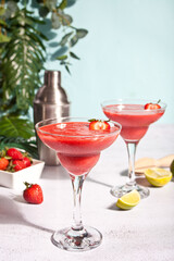 Cold strawberry margarita or daiquiri cocktail with lime and rum