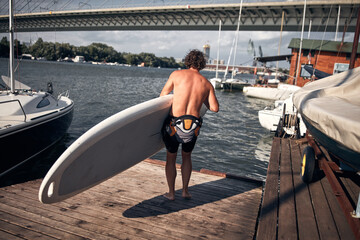 Naklejka premium Windsurfer surfing on a windy day at the river.
