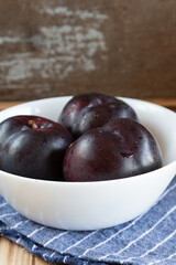 fresh fruit plums on rustic background