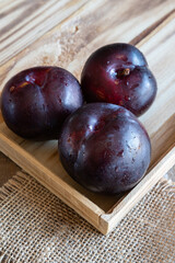 fresh fruit plums on rustic background