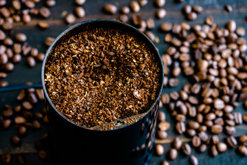 Coarsely Ground Coffee Beans in a Grinder: Coffee grounds in an electric coffee grinder