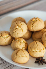 
There is a bowl of delicious cookies on the table.