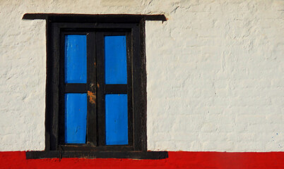old window in the wall, Vintage closed blue and black shutters, and wooden windows isolated on white background with copy space.