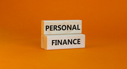Personal finance symbol. Wooden blocks with words Personal finance on beautiful orange background,...