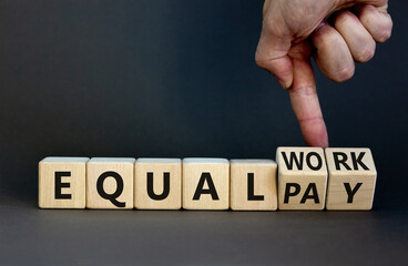 Equal pay and work symbol. Businessman turns wooden cubes and changes words equal pay to equal...