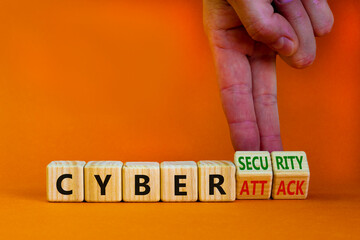 Cyber-security vs cyber-attack symbol. Businessman turns wooden cubes, changes words Cyber-attack to cyber-security. Beautiful orange background. Cyber-security vs cyber-attack concept. Copy space.